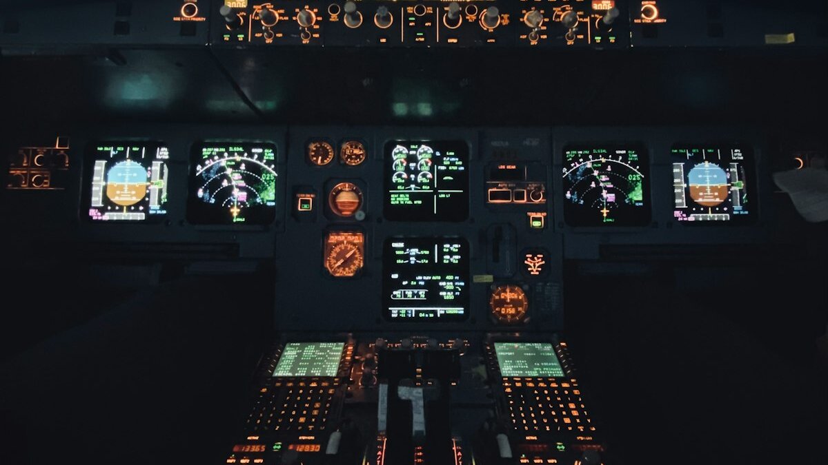Airbus glass cockpit at night — illuminated flight displays and instrument panel